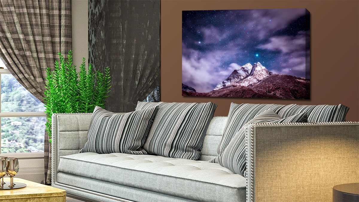Canvas print of the night sky hung in a sitting room