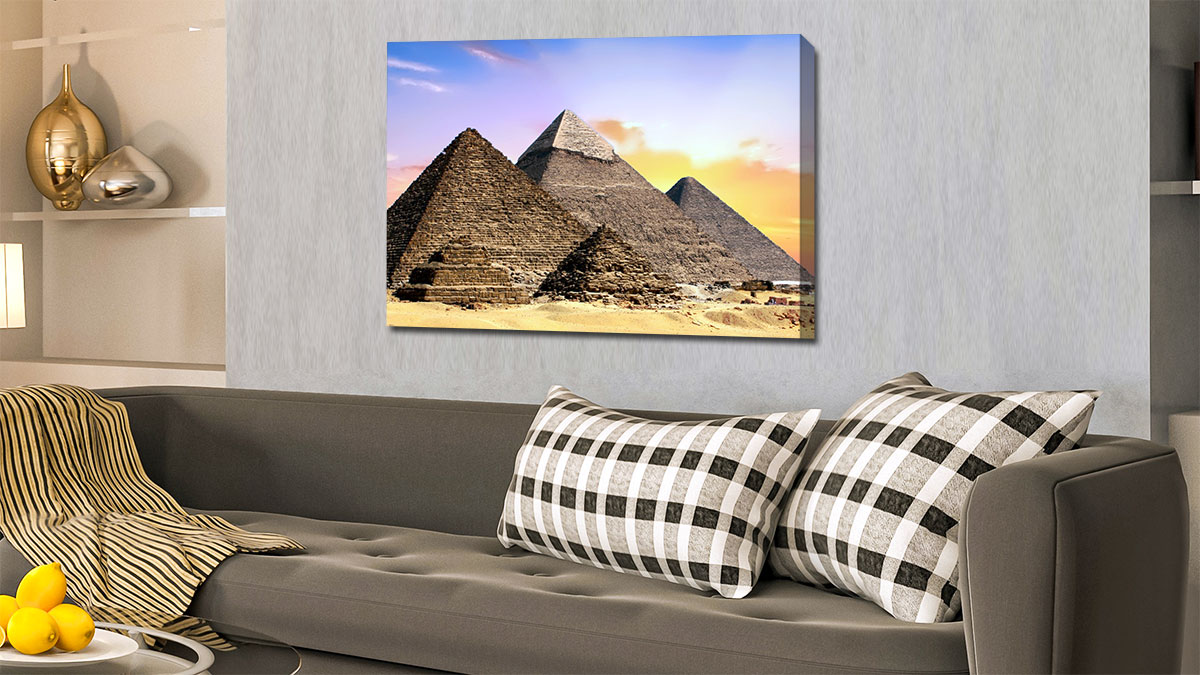 Canvas print of the pyramids hanging on a wall above a sofa