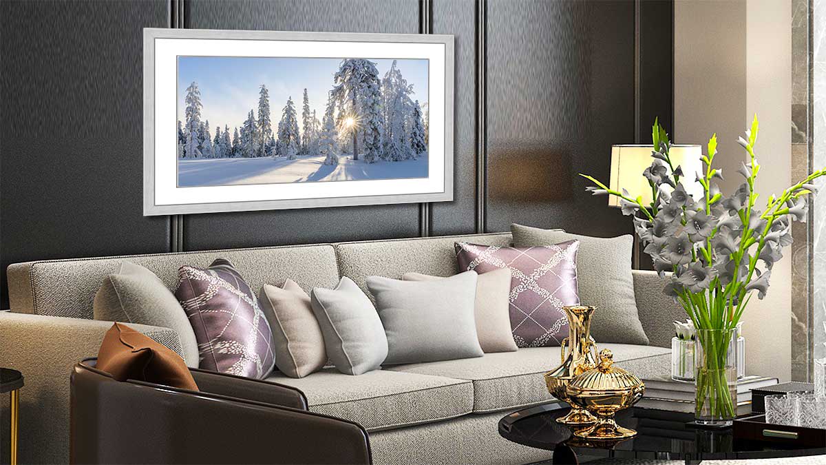 Framed panoramic poster of a snow scene hung above a settee
