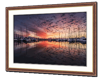Sunset image of a marina framed in stained wood