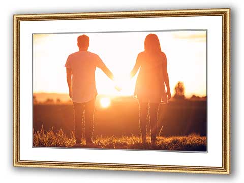 Framed poster of a couple holding hands in the sunset