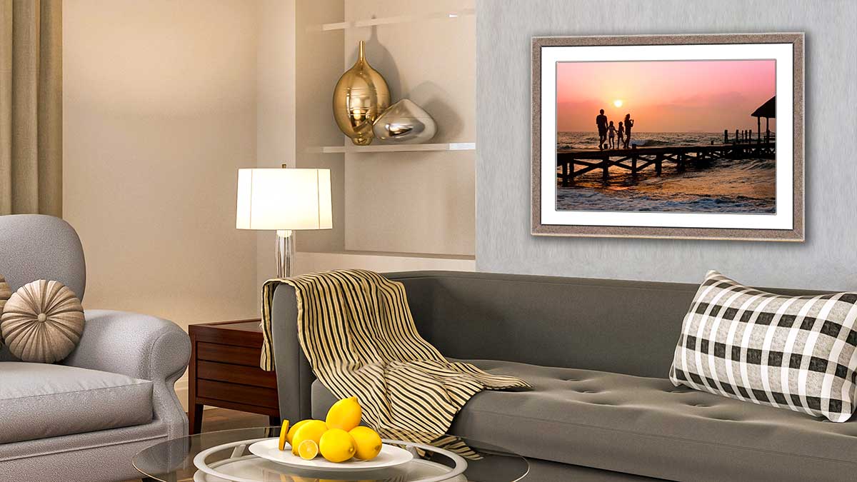 Family holiday snap in a wooden frame hung in a sitting room